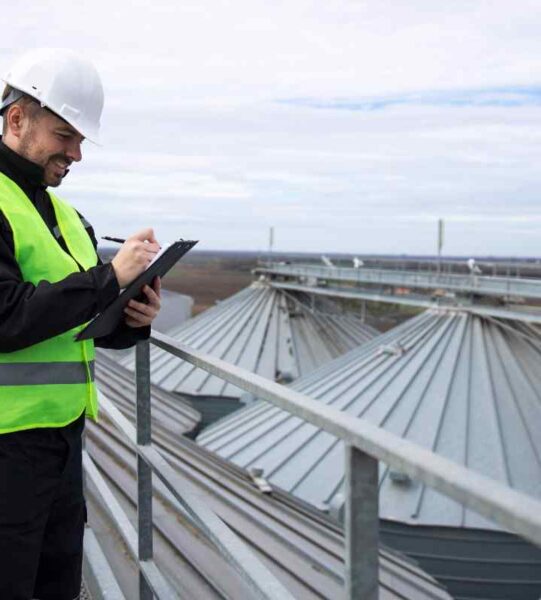 portrait-construction-worker-standing-rooftops-high-silos-storage-tanks-working-tablet-computer (1)